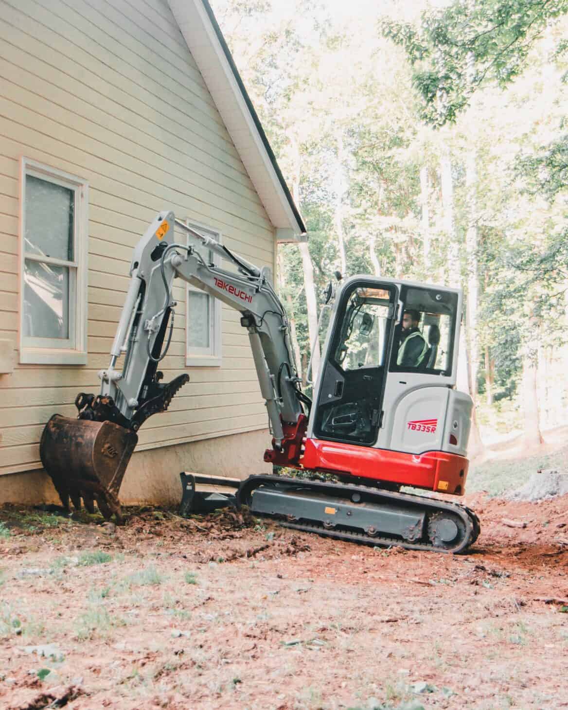 Takeuchi Mini Excavator Cleaning Edge of House