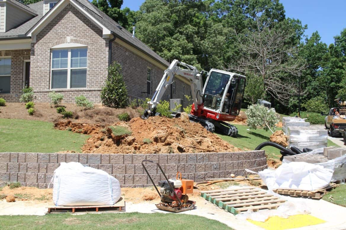 Takeuchi Mini Excavator Digging Seawall